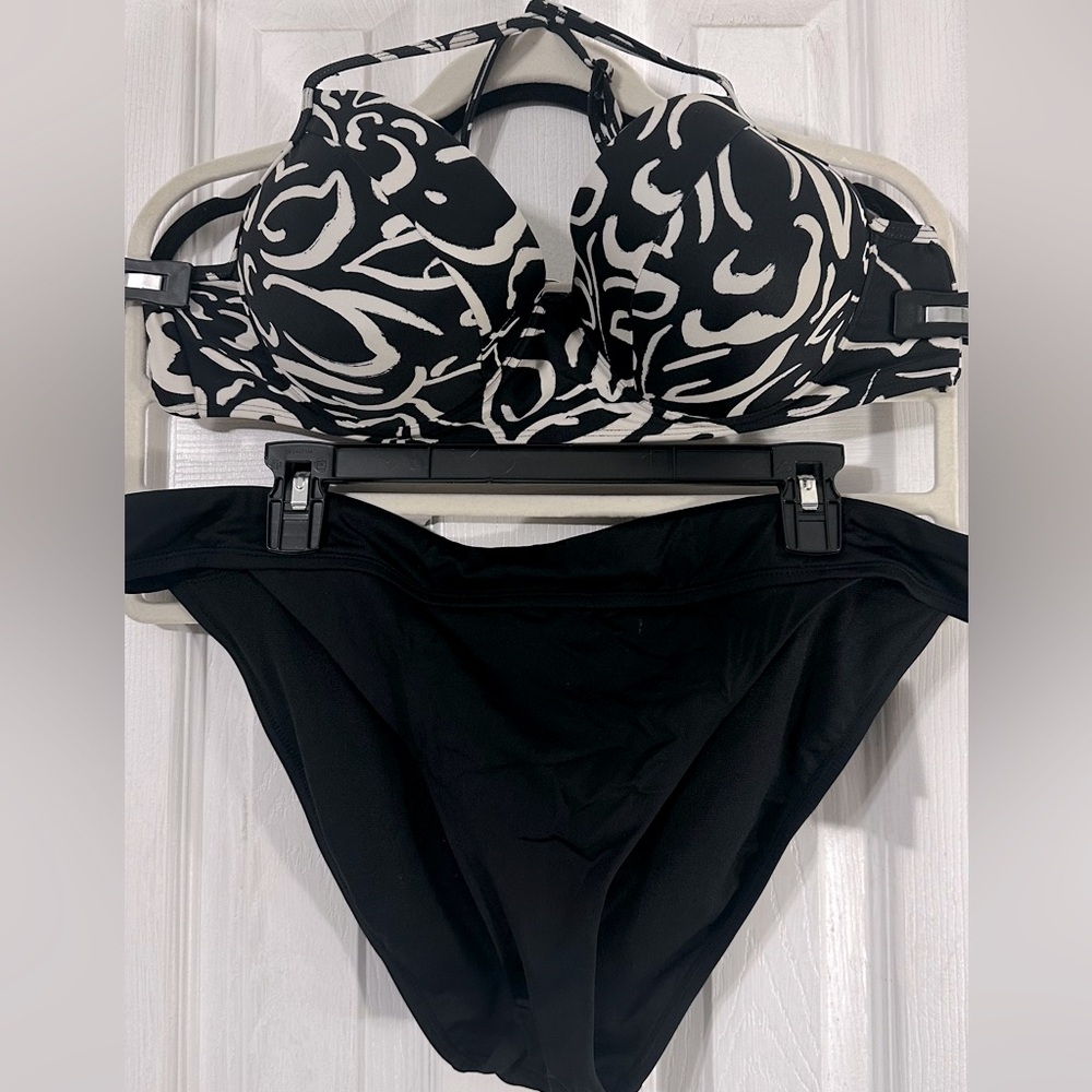 Black and white bikini top with solid black bottoms.